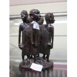 A carved wooden African figural group of six men