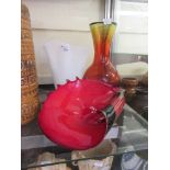 A white glass handkerchief vase together with a bulbous red glass vase and a red shell design bowl