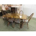 An Ercol kitchen table along with a set of six (Four plus two) matching chairs