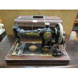 An early 20th century cased Rushby manual sewing machine