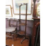 An early 20th century oak three tier folding cake stand