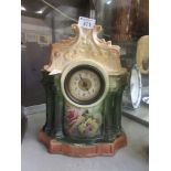 A ceramic mantle clock with floral design