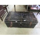 A black military style school tin travelling trunk