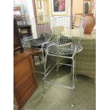 A pair of chrome wirework high stools