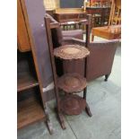 An Indian carved teak three tier cake stand