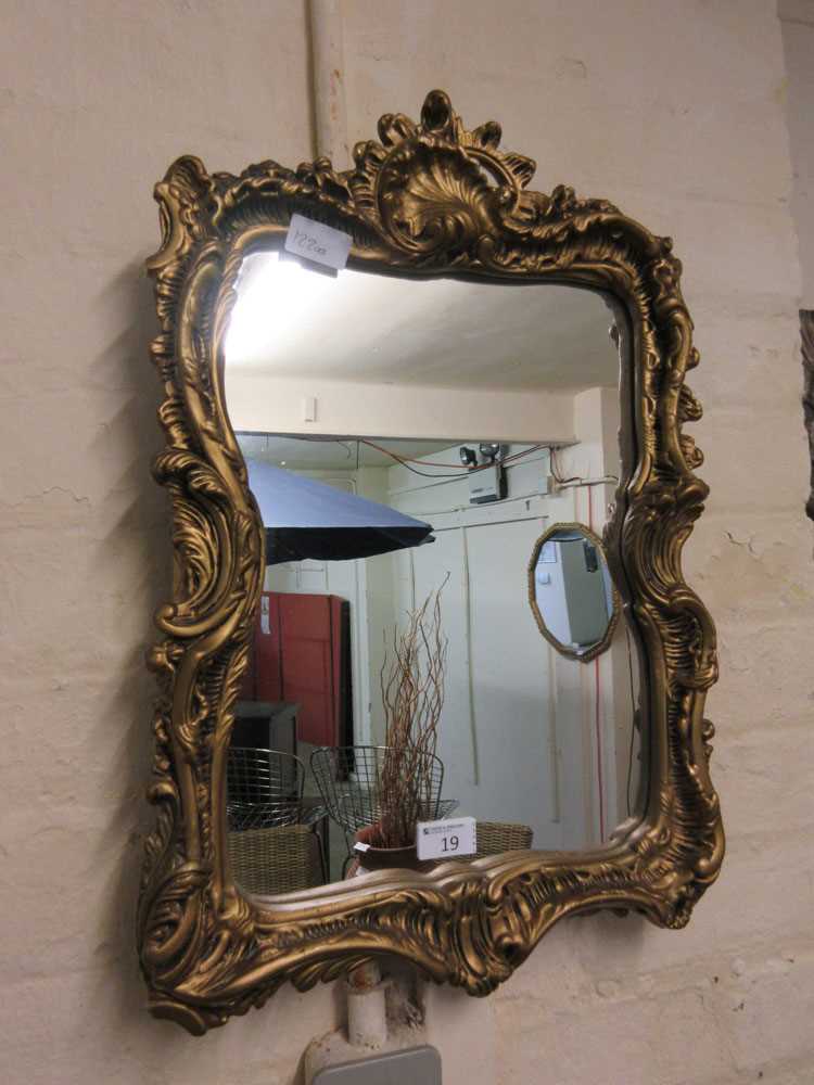 An ornate gilt framed mirrorDimensions; H, 54cm , W, 37cm.