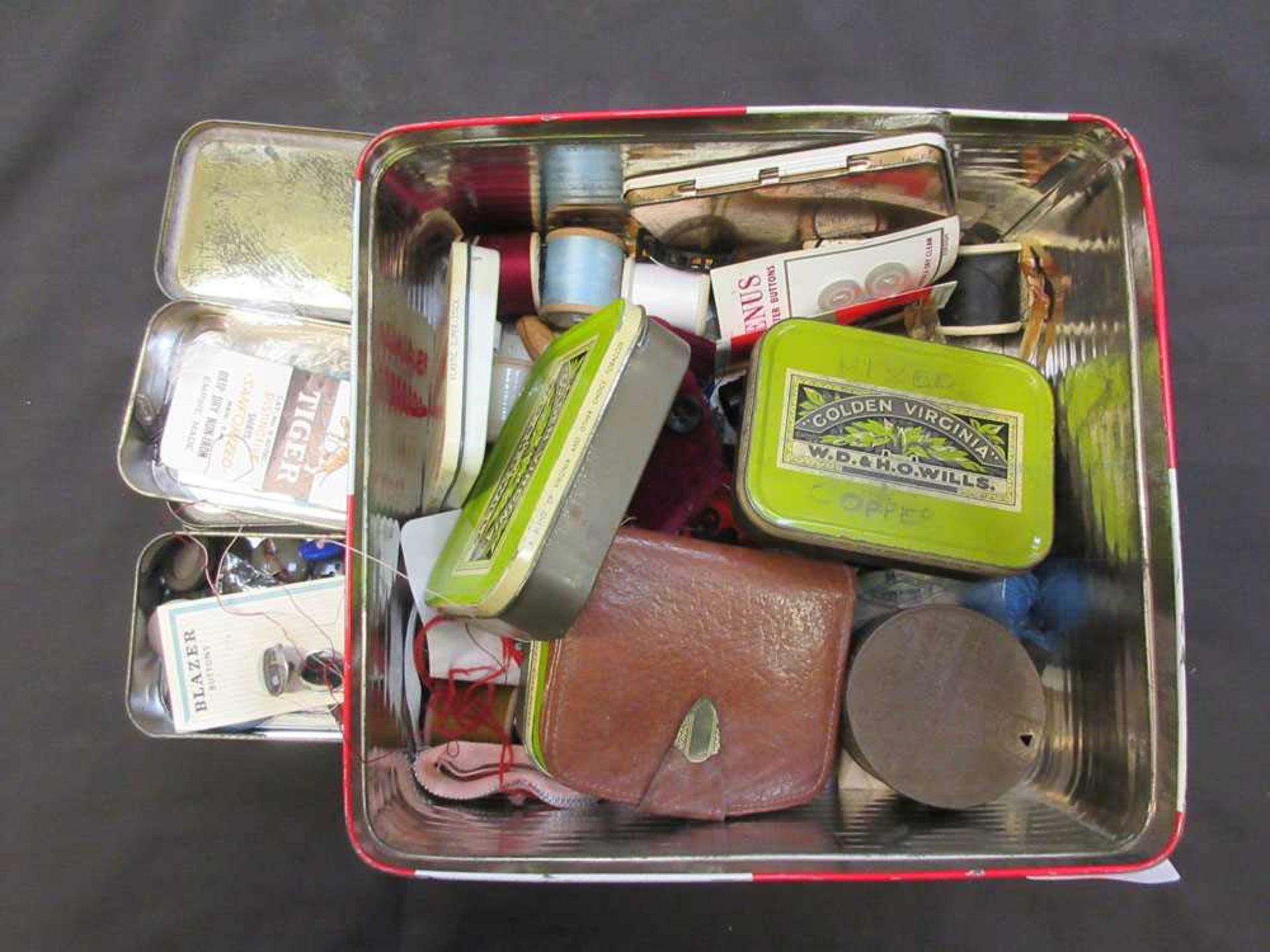 A tin containing sewing accessories, old tins, coinage, etc