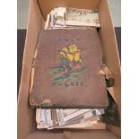 A box containing a quantity of postcards, some in album