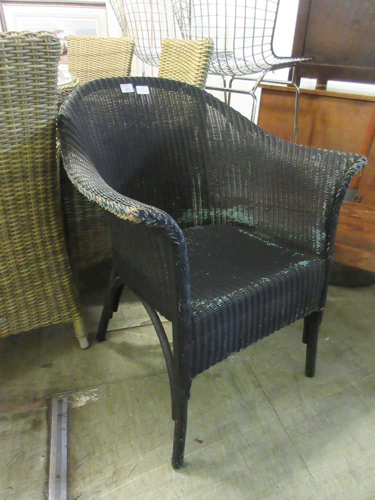 A black painted Lloyd Loom style chair