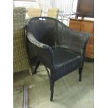A black painted Lloyd Loom style chair