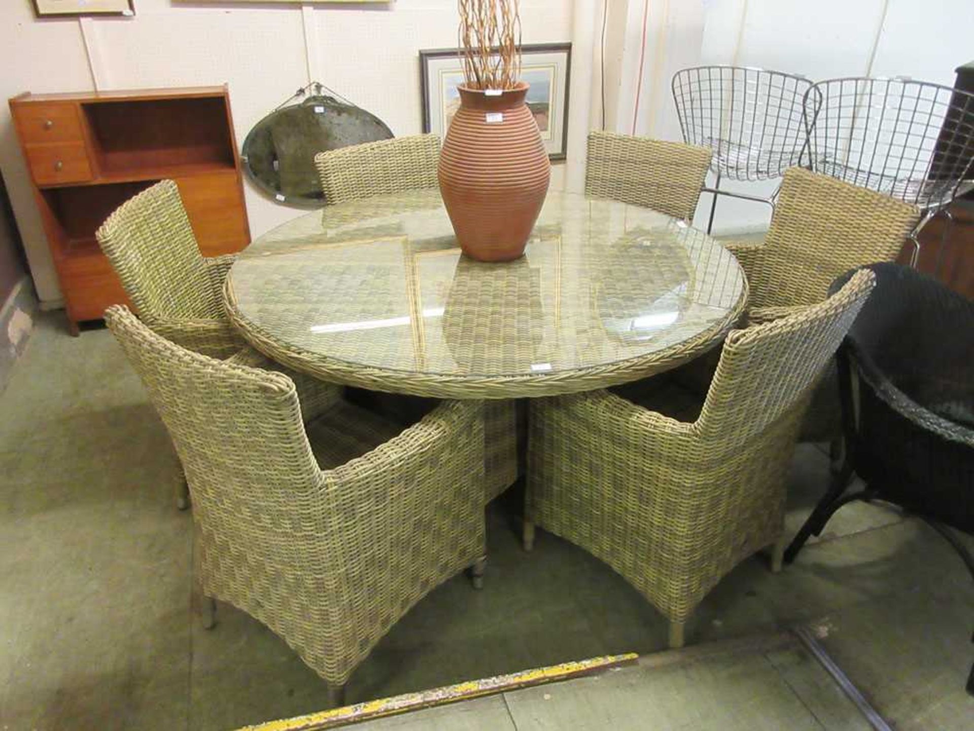 A garden set comprising of six armchairs and a circular tableThe chairs in this lot do not come with