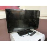 A Hisense flat screen TV with remote