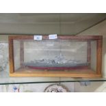 A hand crafted model of military boat in a perspex and oak case