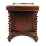 A 19th century rosewood Davenport, the quatrefoil pierced galleried top over the slope with tooled