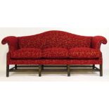 A modern 18th century style stained beech three seat sofa upholstered in a red and gold floral