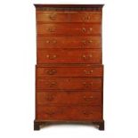 A mid 18th century oak chest on chest, the cornice over two short and three long drawers on the base