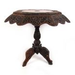 A late 19th century Indian carved occasional table, the octagonal top with carved banding