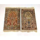 Two hand-woven Persian rugs, the triple line borders surrounding the fields with vase of flowers