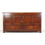 An 18th century oak mule chest, the lift up top revealing a vacant interior over the four panel