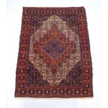 A hand-woven Persian rug, the triple line border surrounding the blue ground field with three