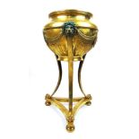 A 19th century brass neoclassical style jardinier, the body with swags and lion masks on a tripod