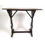 A late 17th century oak occasional table, the moulded top on pierced and shaped end supports, h.