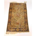 A handwoven Persian silk rug, the main border with animal motifs surrounding the cream ground