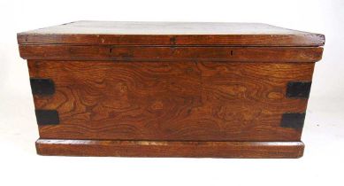 A 19th century elm trunk, the top lifting to reveal a paper lined interior over iron carry