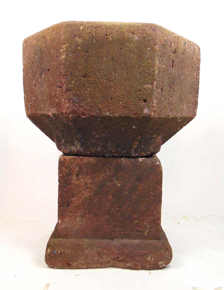 A possible Norman carved sandstone font, the bowl in an octagonal body tapering to the square base