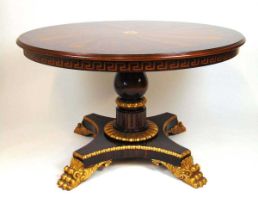 An early 19th century style parcel gilt and specimen wood centre table, the Ceylonese inspired top