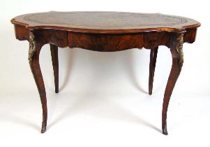 A 19th century French walnut, kingwood banded and brass mounted free standing writing table, the