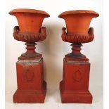W. Meeds & Son of Sussex, a pair of 19th century terracotta garden urns with mask handle terminals