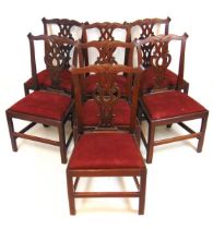 A set of seven 18th century possibly Irish mahogany dining chairs, the carved and shaped cresting
