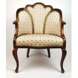 An early 20th century mahogany and strung tub chair upholstered in a floral patterned fabric, the