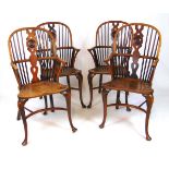 A set of four early 20th century elm, ash and yew Windsor chairs, the comb back with shaped and