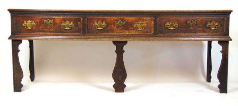 A early 18th century oak dresser, the moulded top over three drawers on flat cut 'silhouette'