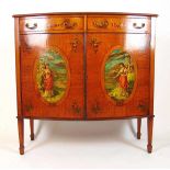 An early 20th century satinwood and artistically painted bow front side cabinet, the top with