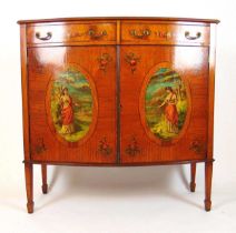 An early 20th century satinwood and artistically painted bow front side cabinet, the top with