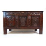 A late 17th century style oak coffer, the top lifting to reveal a vacant interior over the three