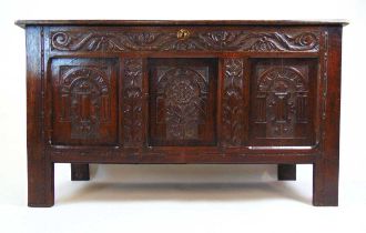 A late 17th century style oak coffer, the top lifting to reveal a vacant interior over the three