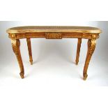 An early 20th century giltwood stool, the kidney shaped caned seat on acanthus carved cabriole