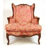 A reproduction 18th century French style walnut framed armchair upholstered in a floral patterned