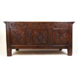 A late 17th century oak coffer, the top lifting to reveal a vacant interior over the three panel
