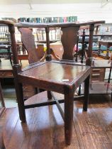 An 18th century pine, elm, oak and fruitwood corner chair, the yoke arms over shaped splats and