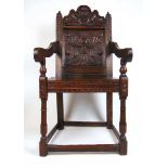 A 19th century, 17th century style oak Wainscot chair, the rose carved top rail over the floral