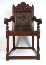 A 19th century, 17th century style oak Wainscot chair, the rose carved top rail over the floral