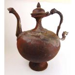 A large middle eastern cast iron vessel, the handle and spout in the form of mythical creatures,