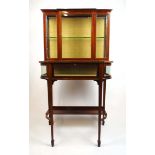 An Edwardian mahogany and boxwood strung display cabinet, the glazed breakfront top over the