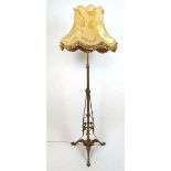 A early 20th century Art Nouveau brass adjustable standard lamp, h. 172 cm No reservoir, converted