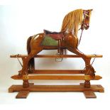 A Stevenson Brothers walnut rocking horse, forward looking head, horse hair mane and tail with